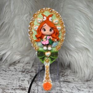 Pebbles Decorative Hand Mirror with Orange Accents